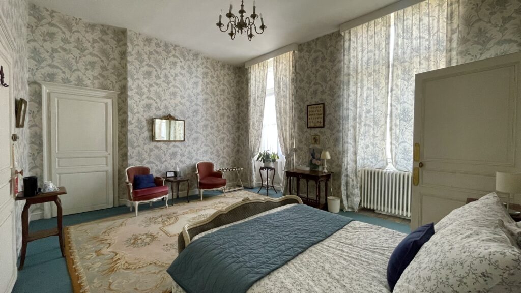 Big bedroom with blue wallpaper